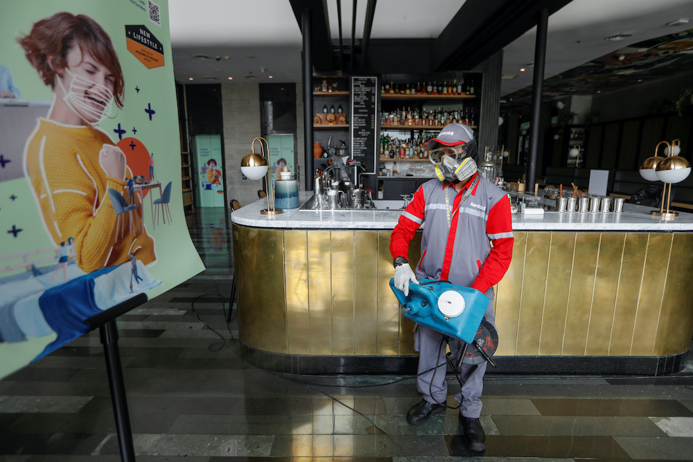 A worker wearing a protective mask and goggles sprays disinfectant at the lobby of Artotel Thamrin, following the coronavirus disease outbreak, in Jakarta, Indonesia, June 26, 2020. u00e2u20acu201d Reuters picnnn