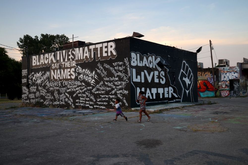 Children run in front of a mural painted on the side of Mad Dog Liquors, June 18, 2020 in Tulsa, Oklahoma. The Black Wall Street Massacre occurred in Tulsa in 1921 and was one of the worst race riots in the history of the United States. u00e2u20acu201d AFP pic