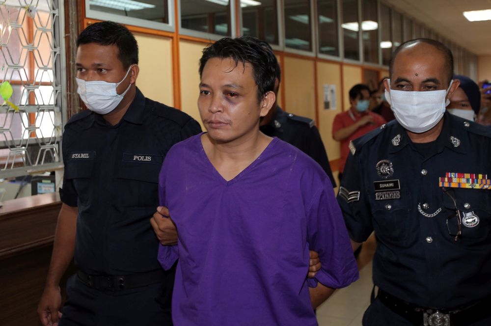 Lorry driver Muhammad Lokman Mohammad Termizi, 29, is escorted by police at the Kuala Kangsar Magistrateu00e2u20acu2122s Court June 2, 2020. u00e2u20acu201d Picture by Farhan Najibnn