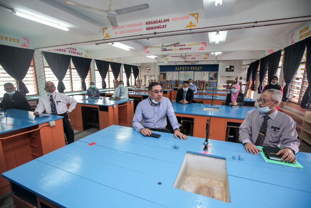 Deputy Education Minister Muslimin Yahaya (centre) is pictured during a visit to Sekolah Menengah Kebangsaan Raja Permaisuri Bainun in Ipoh June 9, 2020. u00e2u20acu201d Picture by Farhan Najib