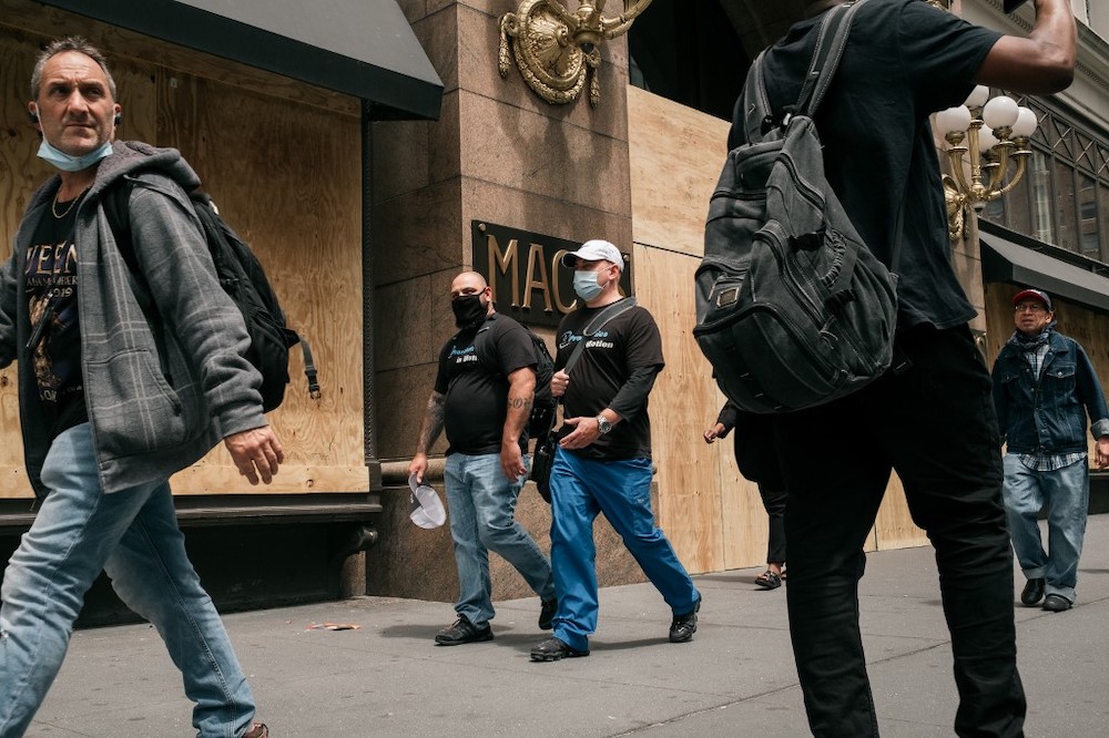 Pedestrians walk by the Macyu00e2u20acu2122s flagship store after workers cleaned and boarded up damage sustained during a night of violent protests and looting in Midtown, Manhattan on June 2, 2020 in New York City. u00e2u20acu2022 Reuters pic