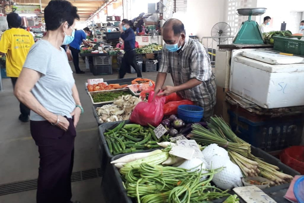 Vegetable seller Azwan Baharin said that this year’s Raya was not as vibrant as the previous ones due to budget constraints and the MCO. — Picture by Anne Grace Savitha