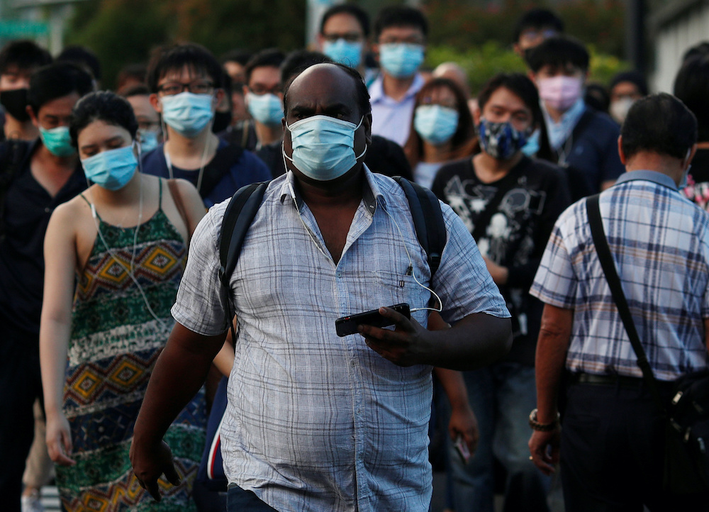 People cross a street during morning peak hour commute amid the coronavirus disease outbreak in Singapore June 3, 2020. u00e2u20acu201d Reuters picnn
