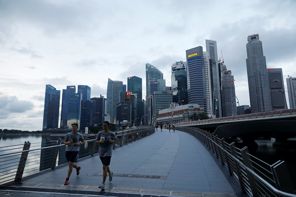 Joggers run near the Merlion Park in Singapore as the city state reopens the economy amid the coronavirus disease outbreak, June 19, 2020. u00e2u20acu2022 Reuters picnn
