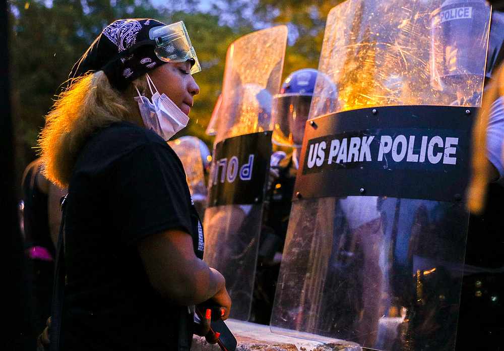 A protestor stands in front of a line of US Park Police riot police as demonstrators try to pull down the statue of US President Andrew Jackson in Washington, June 22, 2020. u00e2u20acu201d Reuters pic