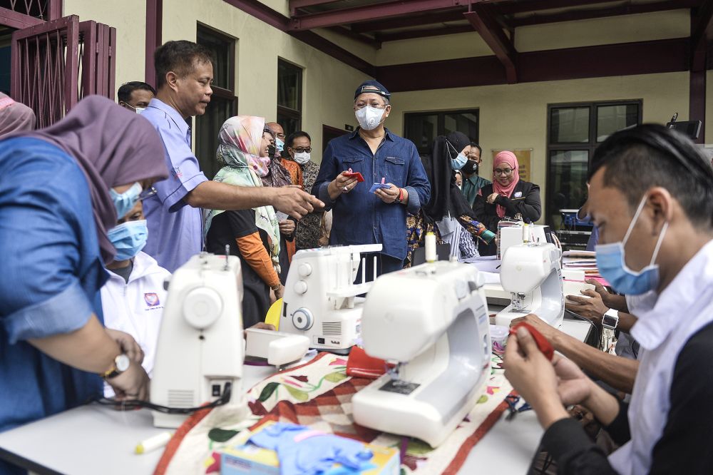 Federal Territories Minister Tan Sri Annuar Musa (centre) visits the homeless at Pusat Transit Gelandangan Kuala Lumpur June 18, 2020. u00e2u20acu201d Picture by Miera Zulyana