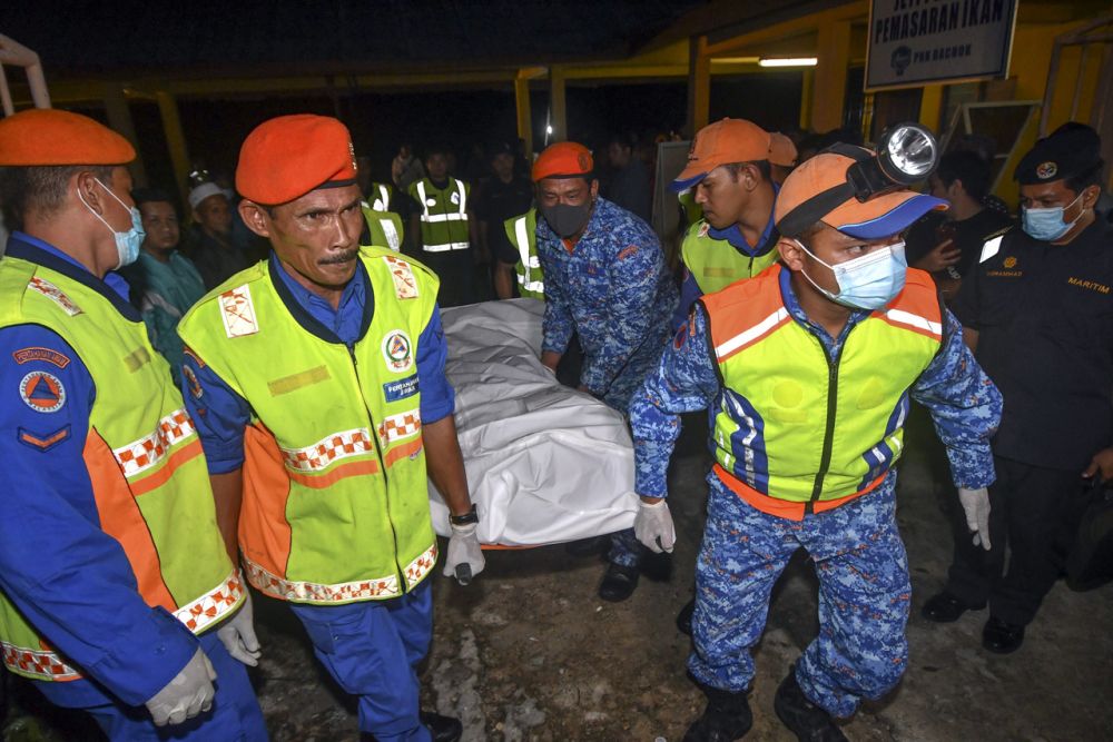 Civil Defence Force personnel retrieve the body of a man found drowned after a boat carrying 20 capsized in Bachok waters June 30, 2020. u00e2u20acu201d Reuters pic