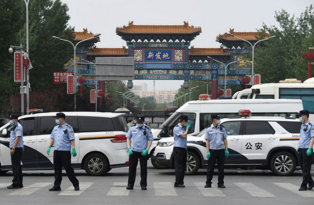 Police guard a Beijing market linked to a new coronavirus cluster. u00e2u20acu201d AFP pic