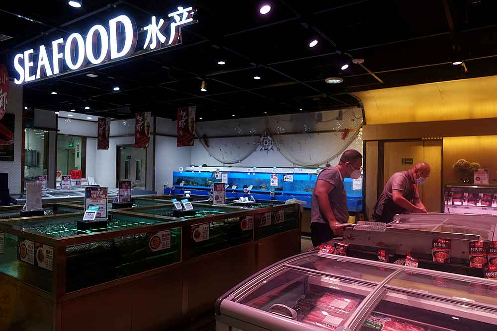 A staff member attends to a customer at a live seafood section inside a supermarket in Beijing, China June 20, 2020. u00e2u20acu201d Reuters pic