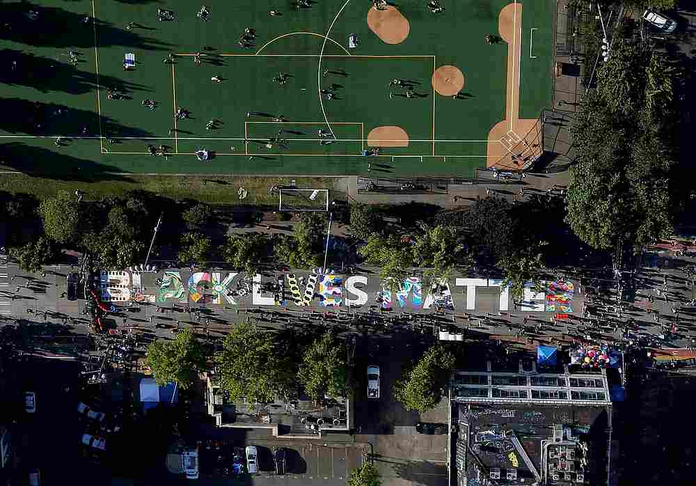 Artists fill in the letters of a 'Black Lives Matter' mural on E. Pine Street calling for the defunding of Seattle police, this aerial photo over Seattle, Washington, June 11, 2020. u00e2u20acu201d Reuters pic
