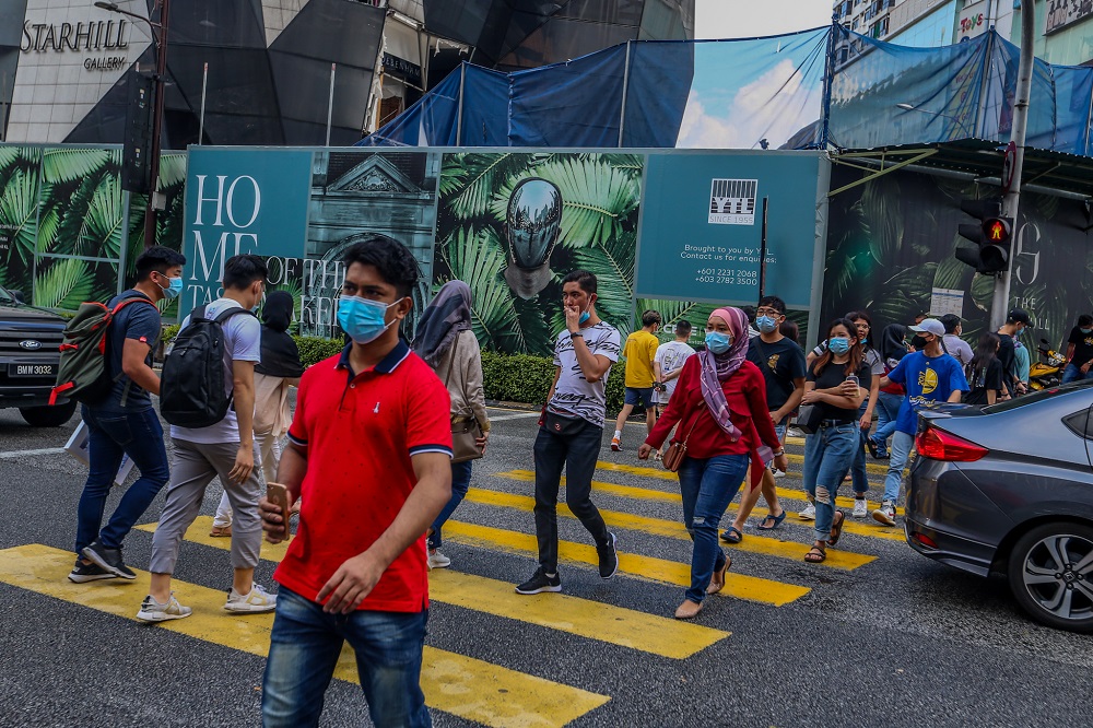 People are seen wearing protective masks as they walk along the Bukit Bintang shopping area in Kuala Lumpur May 31, 2020. u00e2u20acu2022 Picture by Firdaus Latif
