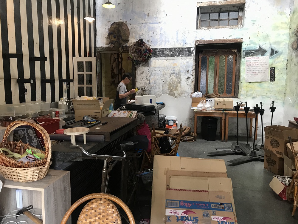 A man is seen packing up some things as the Ipoh's pioneer hipster cafe will shut down its business temporarily.