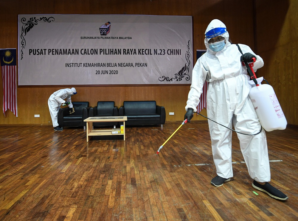 A health worker sanitises the area around the Chini by-election nomination centre in Pekan, June 19, 2020. u00e2u20acu2022 Bernama picn