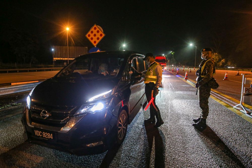 Traffic police and Armed Forces personnel man a roadblock at the Gombak Toll Plaza during the last day of the conditional movement control order on June 9, 2020. u00e2u20acu201d Picture by Hari Anggara