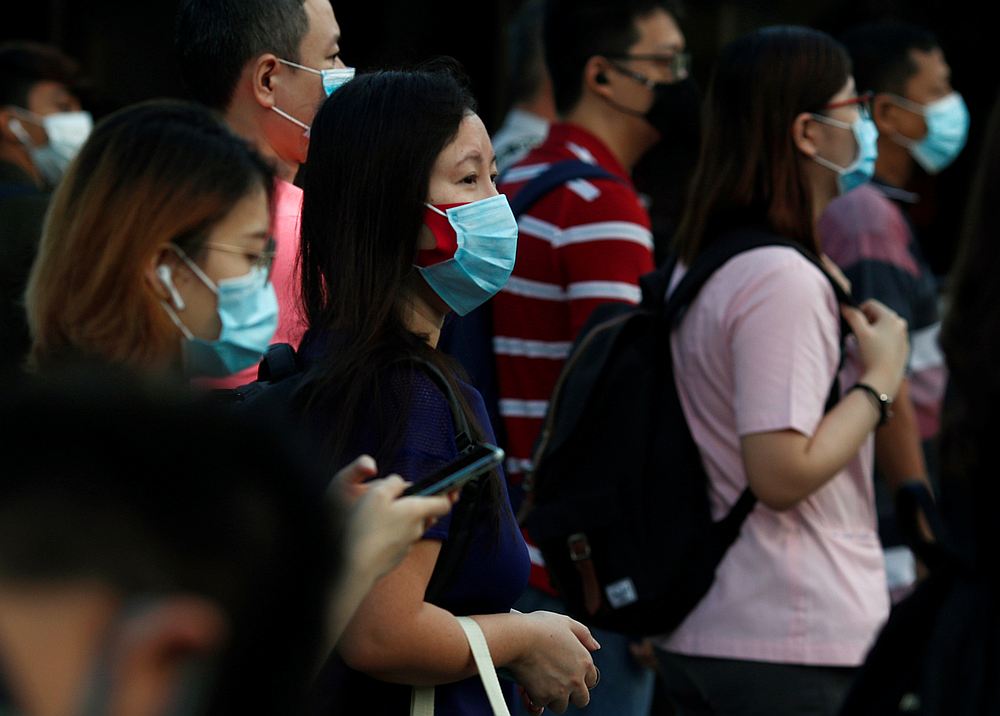 People cross a street during morning peak hour commute amid the Covid-19 outbreak in Singapore June 3, 2020. u00e2u20acu201d Reuters pic