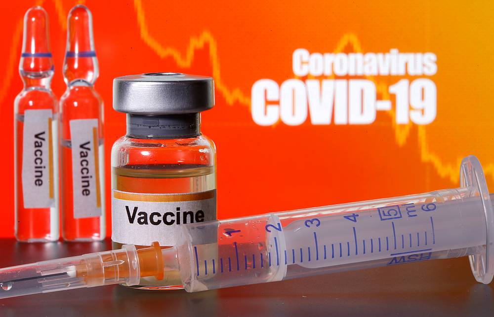 Small bottles labelled with 'Vaccine' stickers stand near a medical syringe in front of displayed 'Coronavirus Covid-19' words in this illustration taken April 10, 2020. u00e2u20acu201d Reuters pic