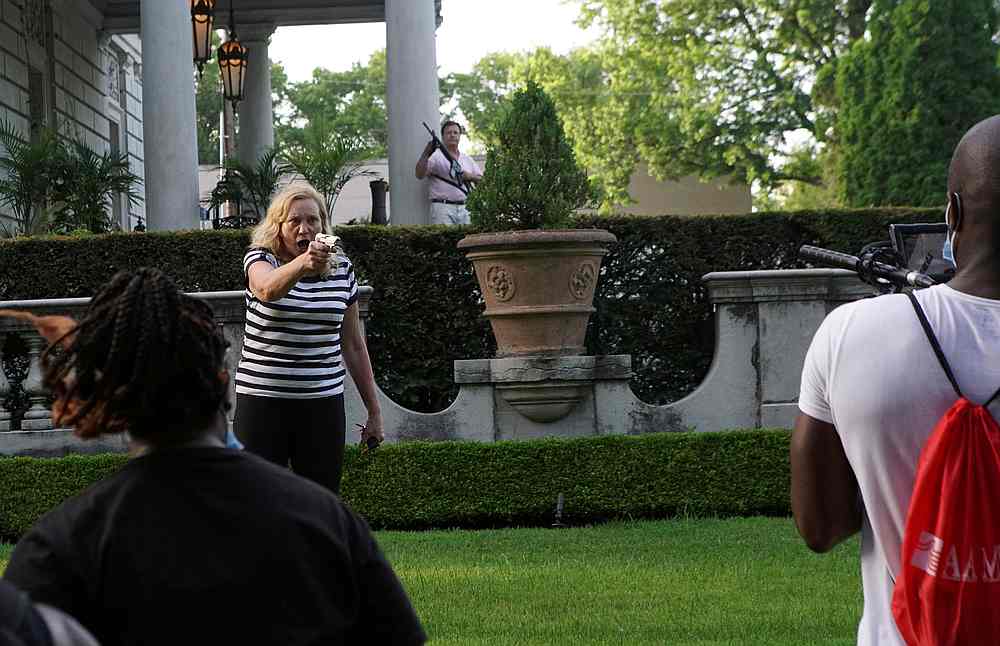 A couple draws firearms on protesters, one of whom holds a video camera and microphone (right), as they enter their neighbourhood in St Louis, Missouri June 28, 2020. u00e2u20acu201d Reuters pic