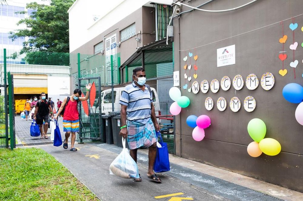 Migrant workers who have recovered from Covid-19, or tested negative twice, returning to Westlite Toh Guan Dormitory on June 12, 2020. u00e2u20acu201d TODAY file pic