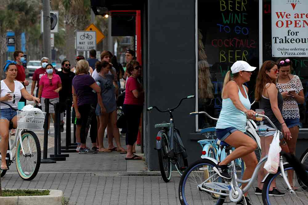 People stand in line at a Duval County restaurant by the beach after it was opened amid Covid-19 restrictions in Jacksonville, Florida April 19, 2020. u00e2u20acu201d Reuters pic