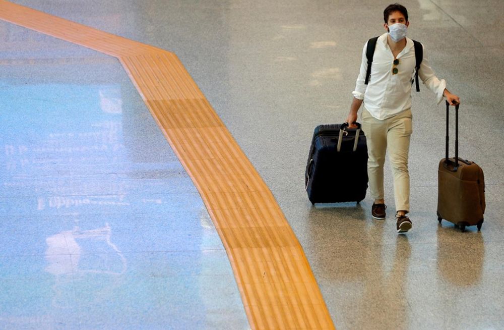 A passenger wearing a protective face mask walks at Fiumicino Airport, where new security measures have been implemented ahead of a further loosening of movement restrictions, in Rome, Italy, May 28, 2020. u00e2u20acu201d Reuters pic
