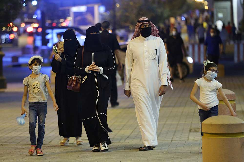 A Saudi family wearing protective face masks walk on Tahlia Street as nightlife kicks off, following the outbreak of Covid-19, in Riyadh, Saudi Arabia June 21, 2020. u00e2u20acu201d Reuters pic