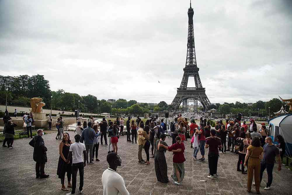 People meet for a dance near The Eiffel Tower in Paris during the French Festival of Music June 21, 2020. u00e2u20acu201d AFP pic