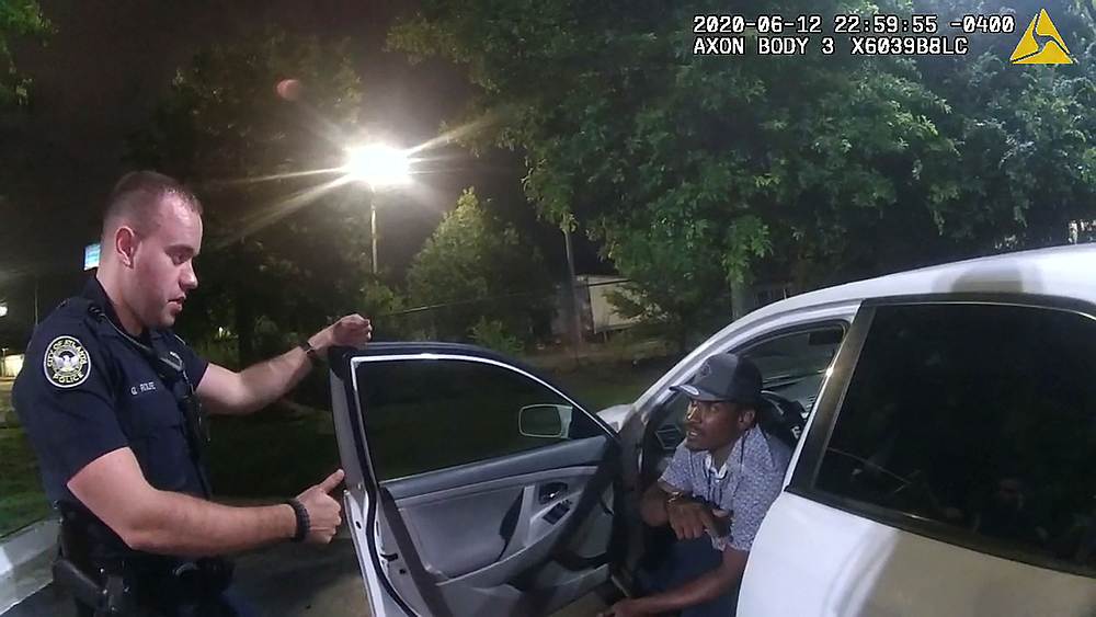 Former Atlanta Police Department officer Garrett Rolfe questions 27-year-old Rayshard Brooks in a Wendy's restaurant parking lot June 12, 2020. u00e2u20acu201d Atlanta Police handout via Reuters 