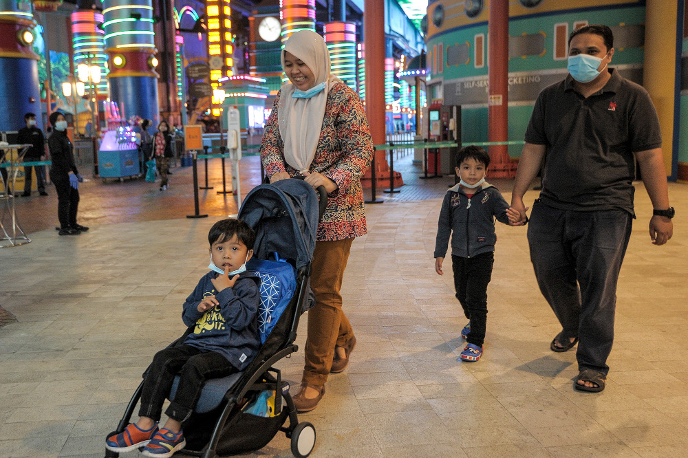 Wan Ismail Azman with his family walking around at the Genting Highlands theme park during the first day of Genting Highlandsu00e2u20acu2122 reopening in Pahang, June 19, 2020. u00e2u20acu201d Picture by Shafwan Zaidon