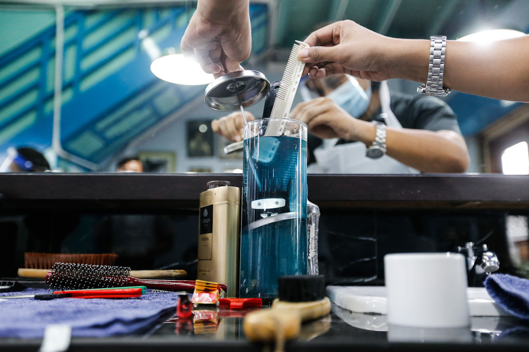 A barber disinfects his tools at the Son And Dad Barber Shop in George Town June 10, 2020. u00e2u20acu201d Picture by Sayuti Zainudin