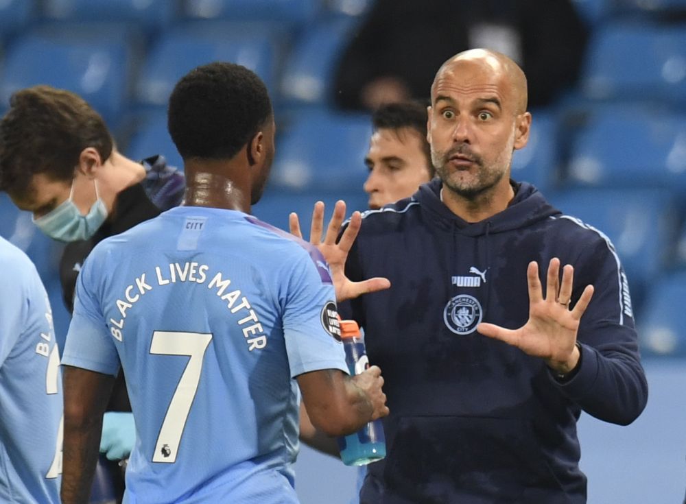 Manchester City manager Pep Guardiola speaks with Raheem Sterling during a drink break in the match against Arsenal at the Etihad Stadium June 17, 2020. u00e2u20acu201d Reuters pic