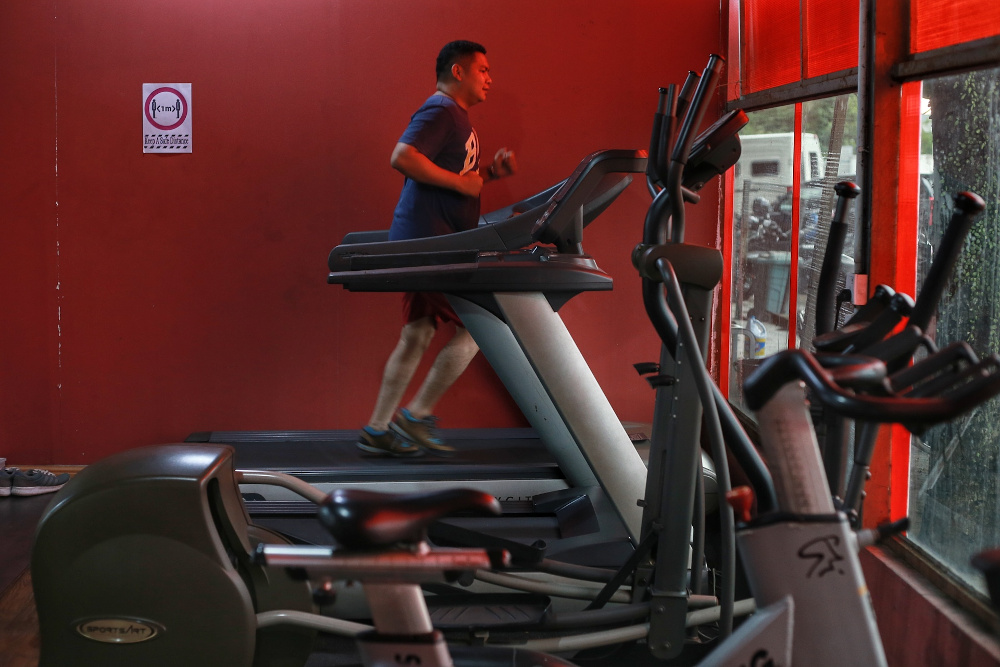 Gym goers start their workouts on the first day of gym reopening while practicing social distance and SOPs at Hyper Gym & Fitness Centre, Kota Damansara, June 15, 2020. u00e2u20acu201d Picture by Ahmad Zamzahuri