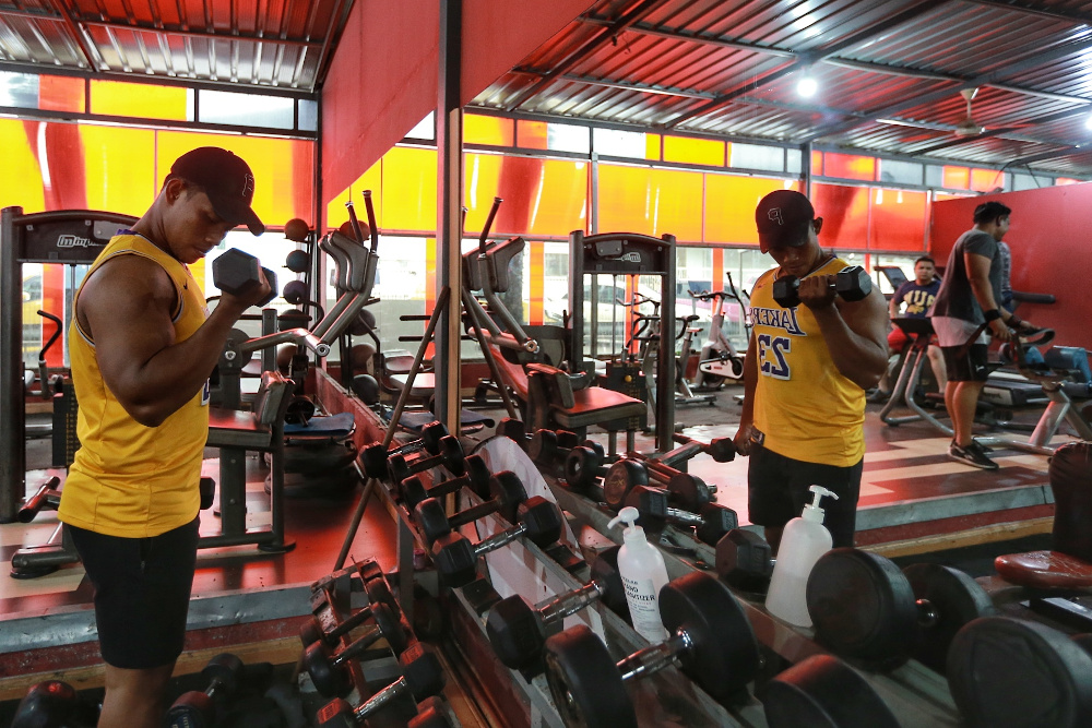 Gym goers start their workouts on the first day of gym reopening while practicing social distance and SOPs at Hyper Gym & Fitness Centre, Kota Damansara, June 15, 2020. u00e2u20acu201d Picture by Ahmad Zamzahuri