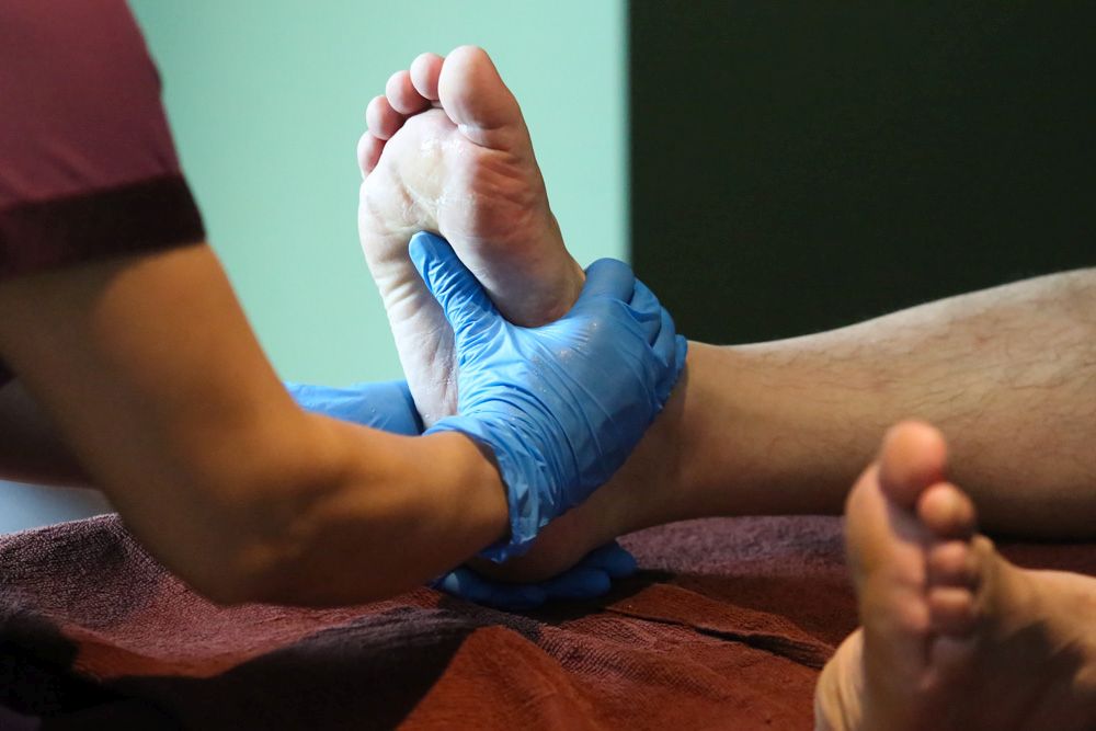 A therapist decked in protectice gear gives a demonstration of standard operating procedures  that will be adhered to during a foot massage at the Healthland Wellness Centre in Sunway Pyramid June 30, 2020. u00e2u20acu201d Picture by Choo Choy May