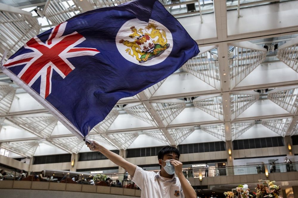 A pro-democracy protester waves a British colonial flag during a u00e2u20acu02dcLunch With Youu00e2u20acu2122 rally in a shopping mall in the Central district in Hong Kong on June 1, 2020. u00e2u20acu201d AFP pic