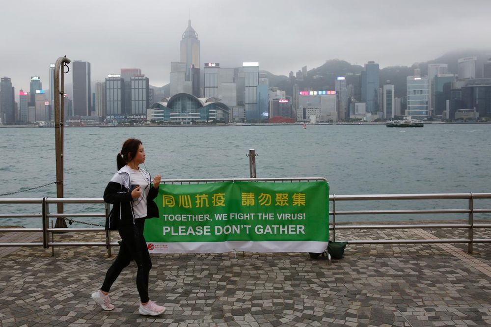 A woman runs past a banner of health advice at Tsim Sha Tsuiu00e2u20acu2122s tourist attraction, following the novel coronavirus disease (Covid-19) outbreak, in Hong Kong, China April 2, 2020. u00e2u20acu201d Reuters pic