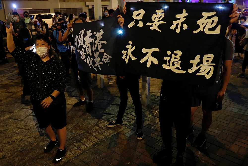 A woman wearing a protective face mask holds up her phone as she attends a candlelight vigil ahead of the anniversary of the crackdown at Beijing's Tiananmen Square in 1989, in Hong Kong, June 3, 2020. u00e2u20acu201d Reuters pic