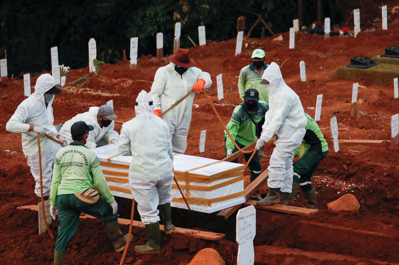 Municipality workers bury a coffin in a grave at a cemetery complex provided by the government for coronavirus disease (Covid-19) victims in Jakarta, Indonesia April, 22, 2020. u00e2u20acu201d Reuters pic