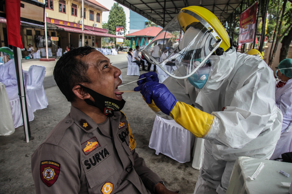 An Indonesian policeman receives a swab test for the Covid-19 amid the outbreak in Medan June 24, 2020. u00e2u20acu201d AFP pic 