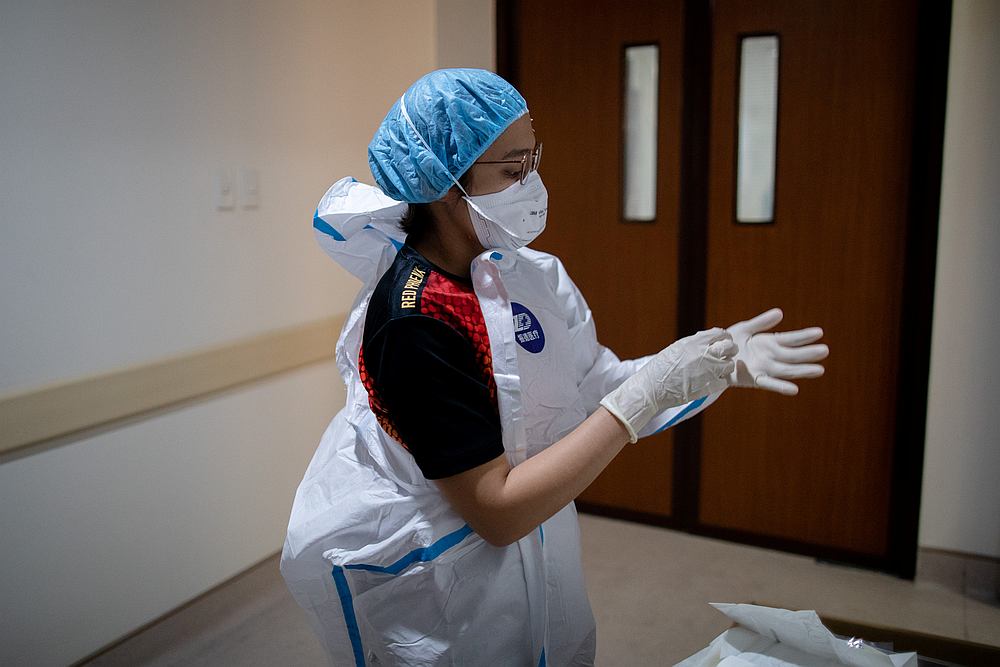 Jan Claire Dorado, 30, puts on personal protective equipment before going in the Covid-19  Emergency Room of East Avenue Medical Centre in Manila, Philippines June 26, 2020. u00e2u20acu201d Reuters pic