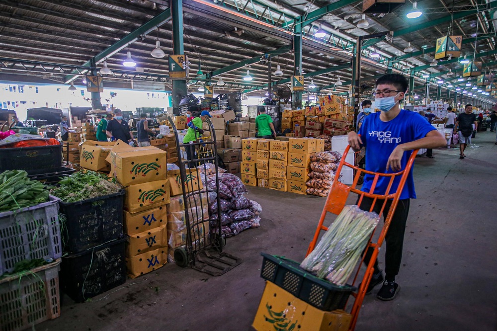 Workers are seen at the Kuala Lumpur wholesale market June 24, 2020. u00e2u20acu2022 Picture by Hari Anggara