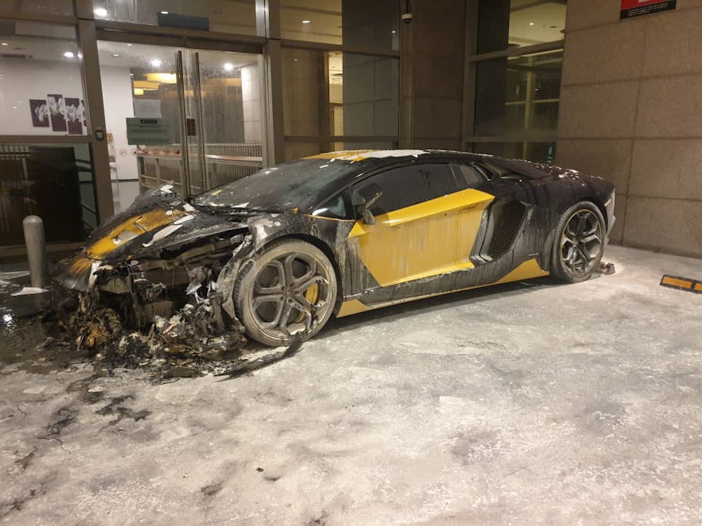 A luxury sports car catches fire at Pavilion Residence parking lot. u00e2u20acu201d Picture courtesy of the Fire and Rescue Department