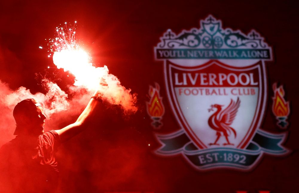Liverpool fans celebrate winning the Premier League with flares outside Anfield after Chelsea won their match against Manchester City June 25, 2020. u00e2u20acu201d Reuters pic