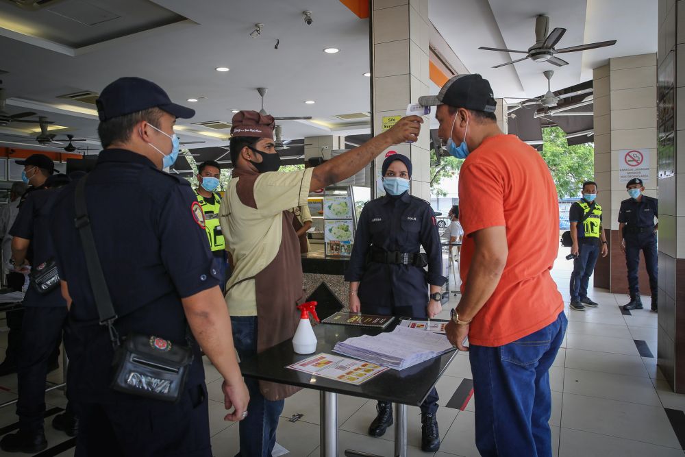 Shah Alam City Council enforcement officers and police personnel conduct checks on a restaurant in Shah Alam June 2, 2020. u00e2u20acu201d Picture by Yusof Mat Isa