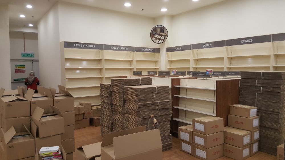 Empty shelves and stacks of boxes loaded with books and stationary are pictured as the MPH MyTown bookstore prepares to close this Saturday, June 6, 2020. — Picture by R. Loheswar