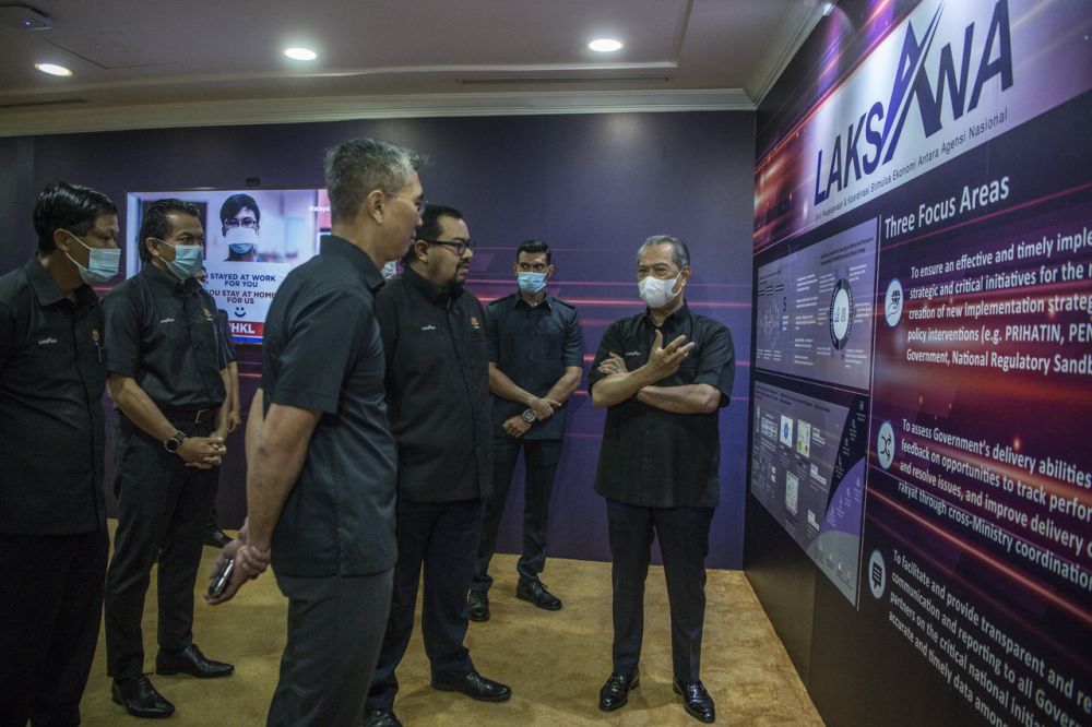 Prime Minister Tan Sri Muhyiddin Yassin (right) visits the Economic Stimulus Implementation and Coordination Unit Between National Agencies at the Finance Ministry in Putrajaya June 16, 2020. u00e2u20acu201d Bernama pic
