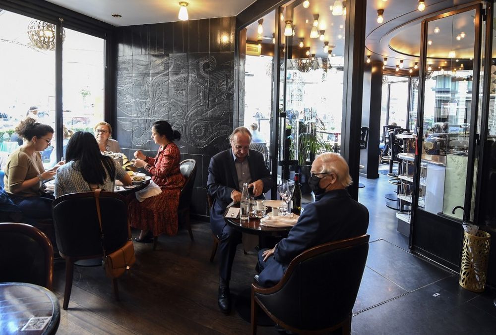Customers eat at the restaurant Garnier in Paris, June 15, 2020, as cafes and restaurants are allowed to serve customers inside, as well as on terraces, as part of the easing of lockdown measures taken to curb the spread of the Covid-19 pandemic. u00e2u20acu201d AFP 