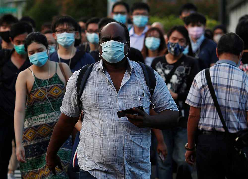 People cross a street during morning peak hour commute amid the Covid-19 outbreak in Singapore June 3, 2020. u00e2u20acu201d Reuters pic