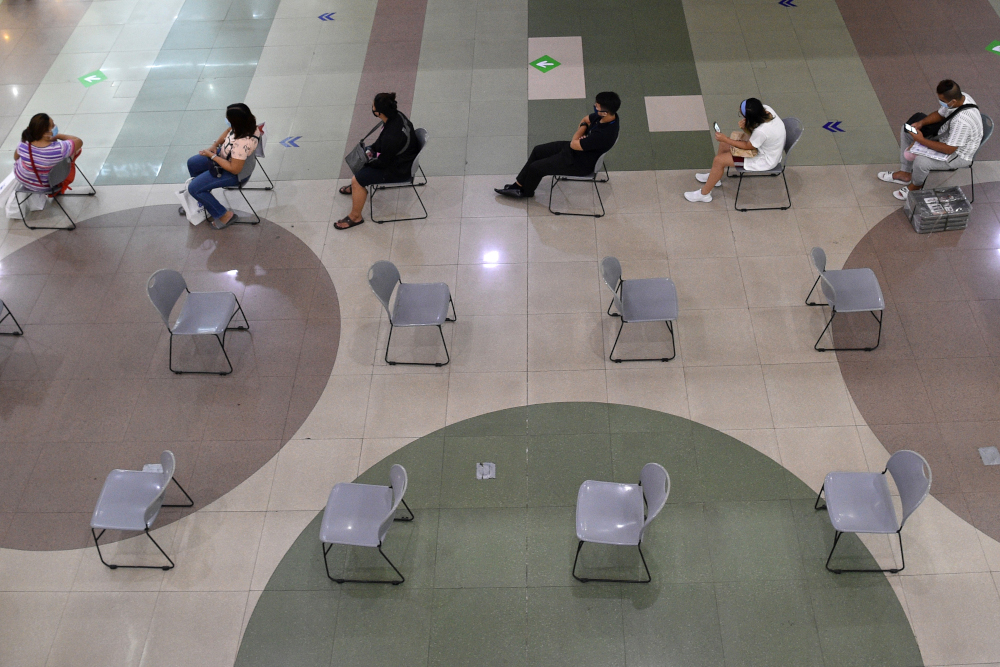 Shoppers sit on chairs as they wait for their turn to enter a grocery store in a mall in Manila June 2, 2020, a day after the government eased up quarantine measures aimed at preventing the spread of the Covid-19 in the countryu00e2u20acu2122s capital. u00e2u20acu201d AFP pic 