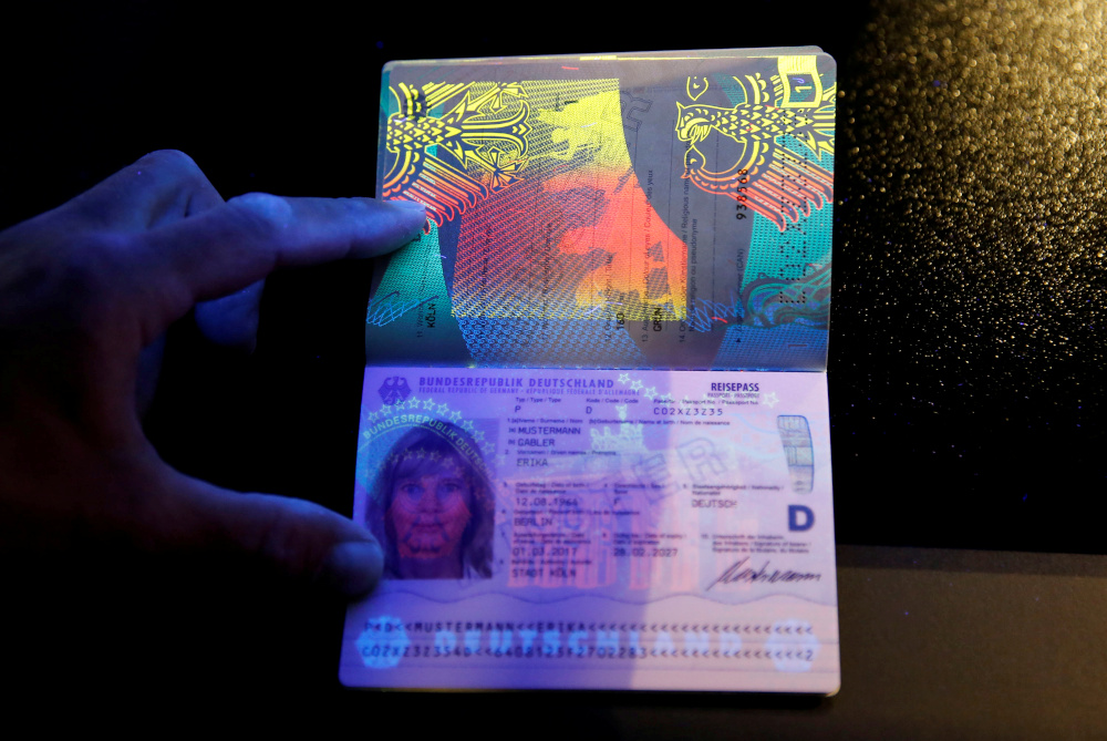 A specimen of the new German electronic passport is pictured under an ultraviolet light during its presentation to the media in Berlin February 23, 2017. u00e2u20acu201d Reuters pic