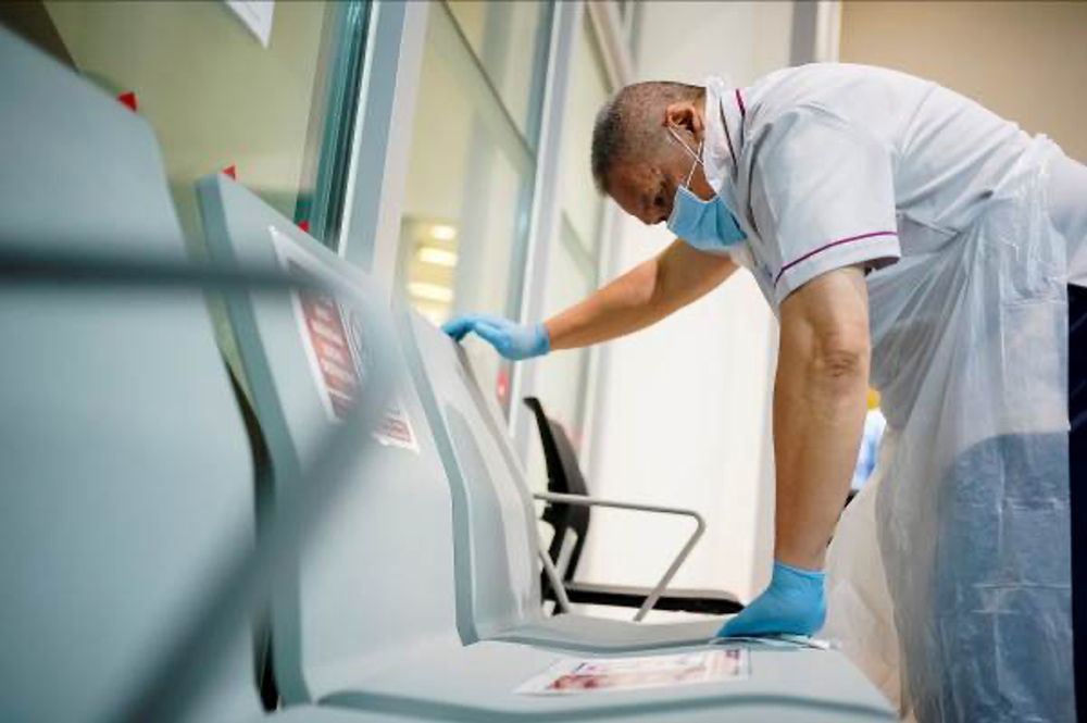 A worker sanitising and disinfecting seats. — Picture via Ng Teng Fong General Hospital/TODAY